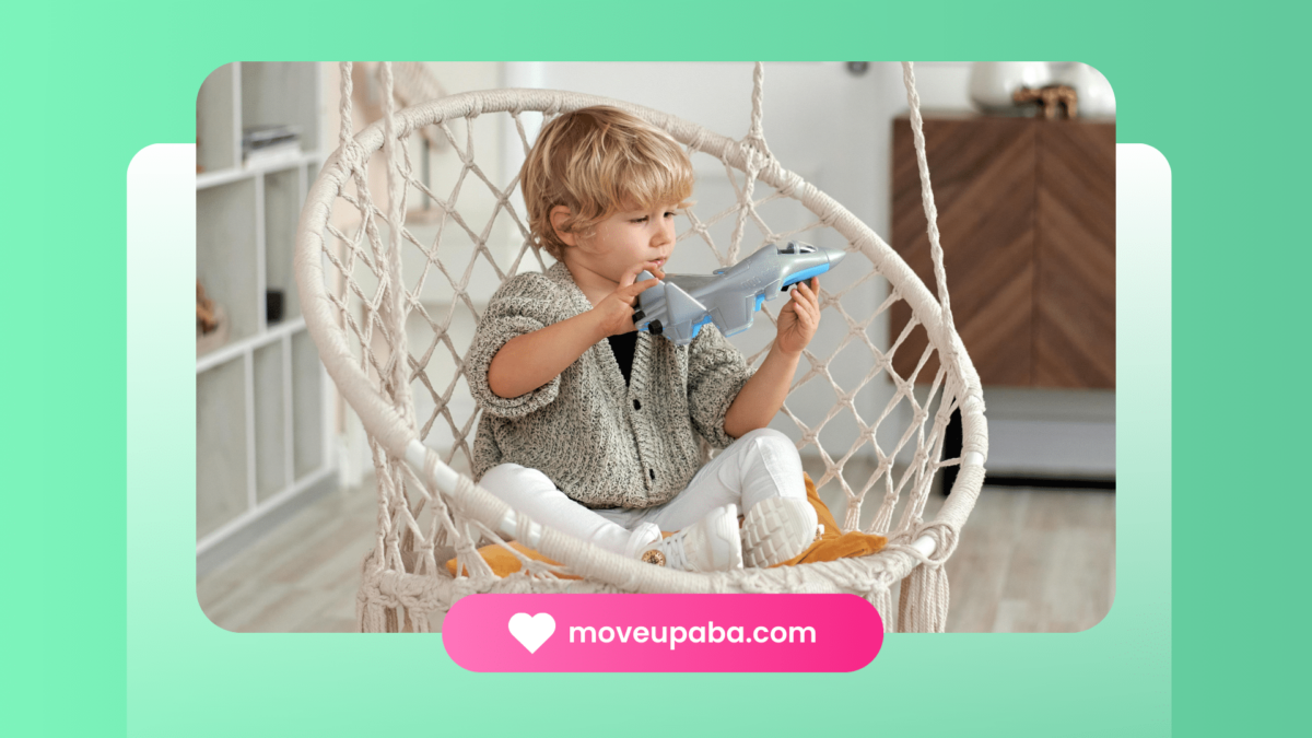 An autistic child taking a short break from ABA therapy, playing with a toy airplane while sitting in a hanging chair