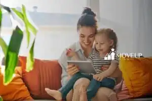 A little girl with her mom, playing tablet