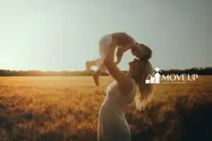 A mother holding his child above her head