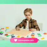 A child with autism working on a colorful alphabet puzzle at a table