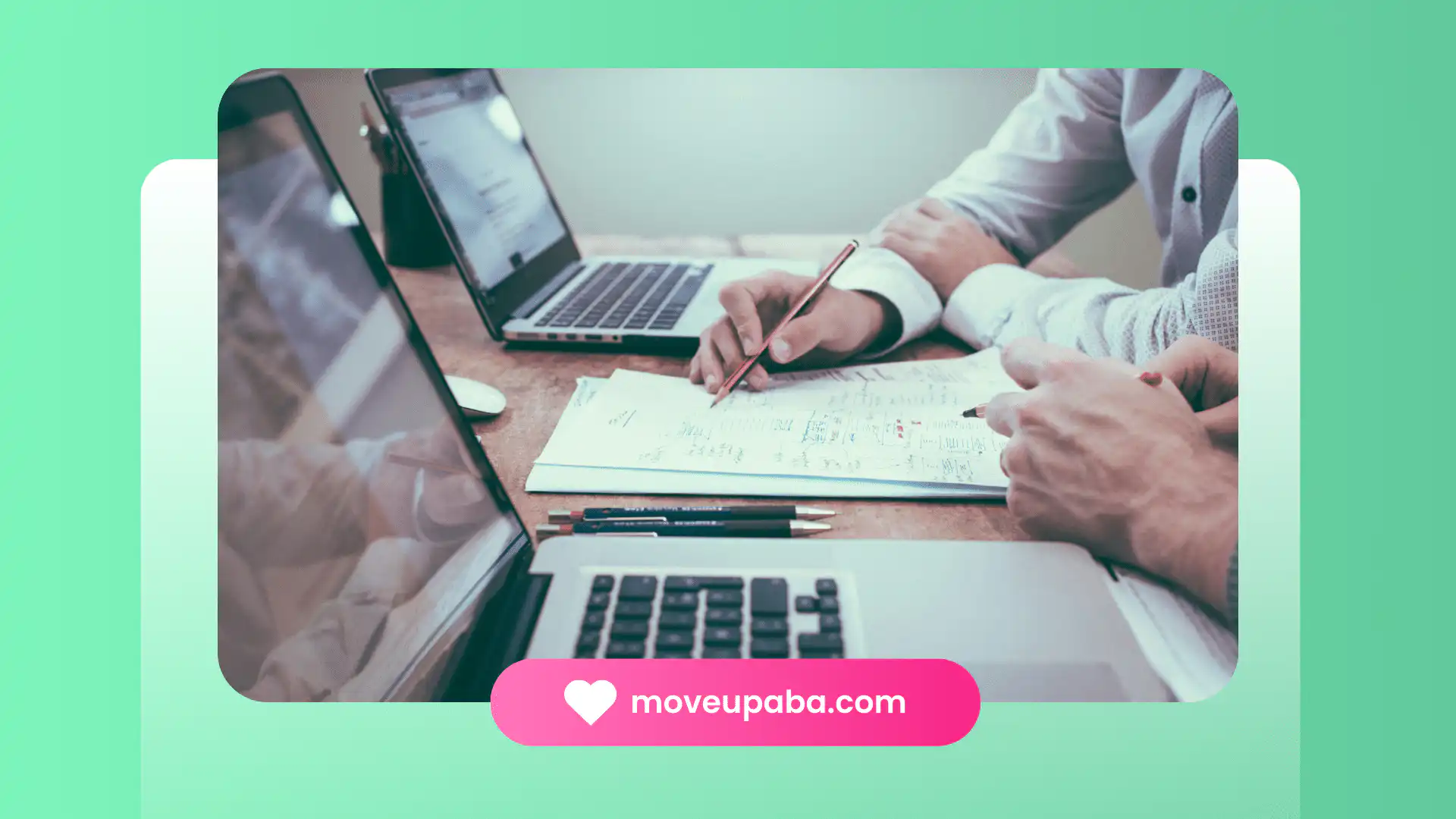 Two people reviewing documents and laptops, discussing insurance coverage for ABA therapy