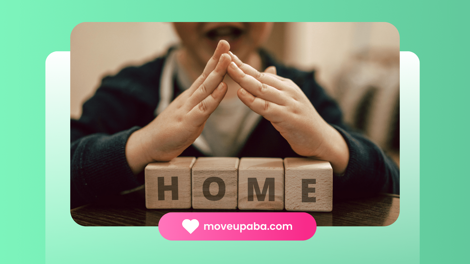 A child forming a roof shape with his hands over wooden blocks spelling "HOME"