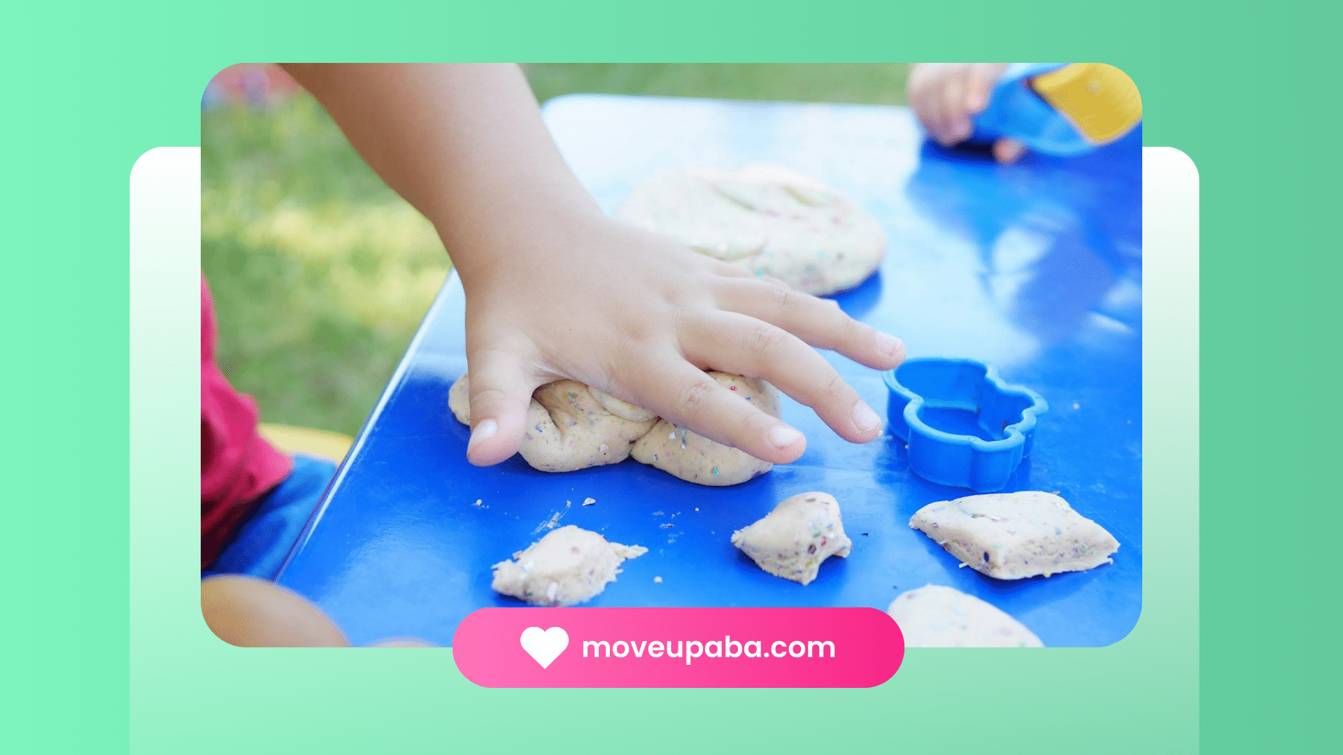 An autistic child's hands shaping playdough with cookie-cutter at an ABA therapy clinic in Maryland.