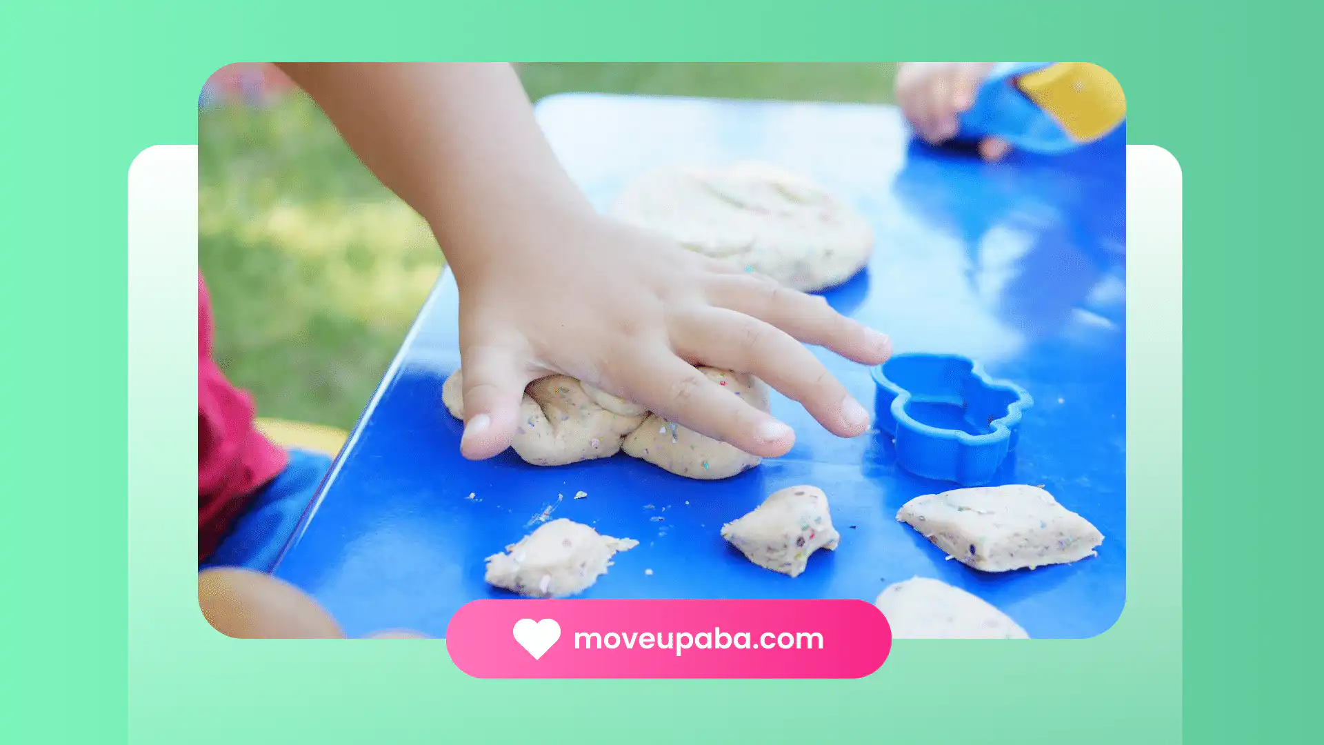 An autistic child's hands shaping playdough with cookie-cutter at an ABA therapy clinic in Maryland.