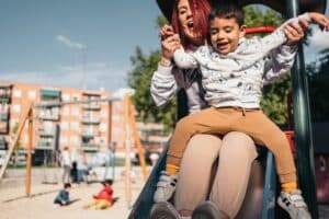 communication skills in autism children with child sliding down a slide