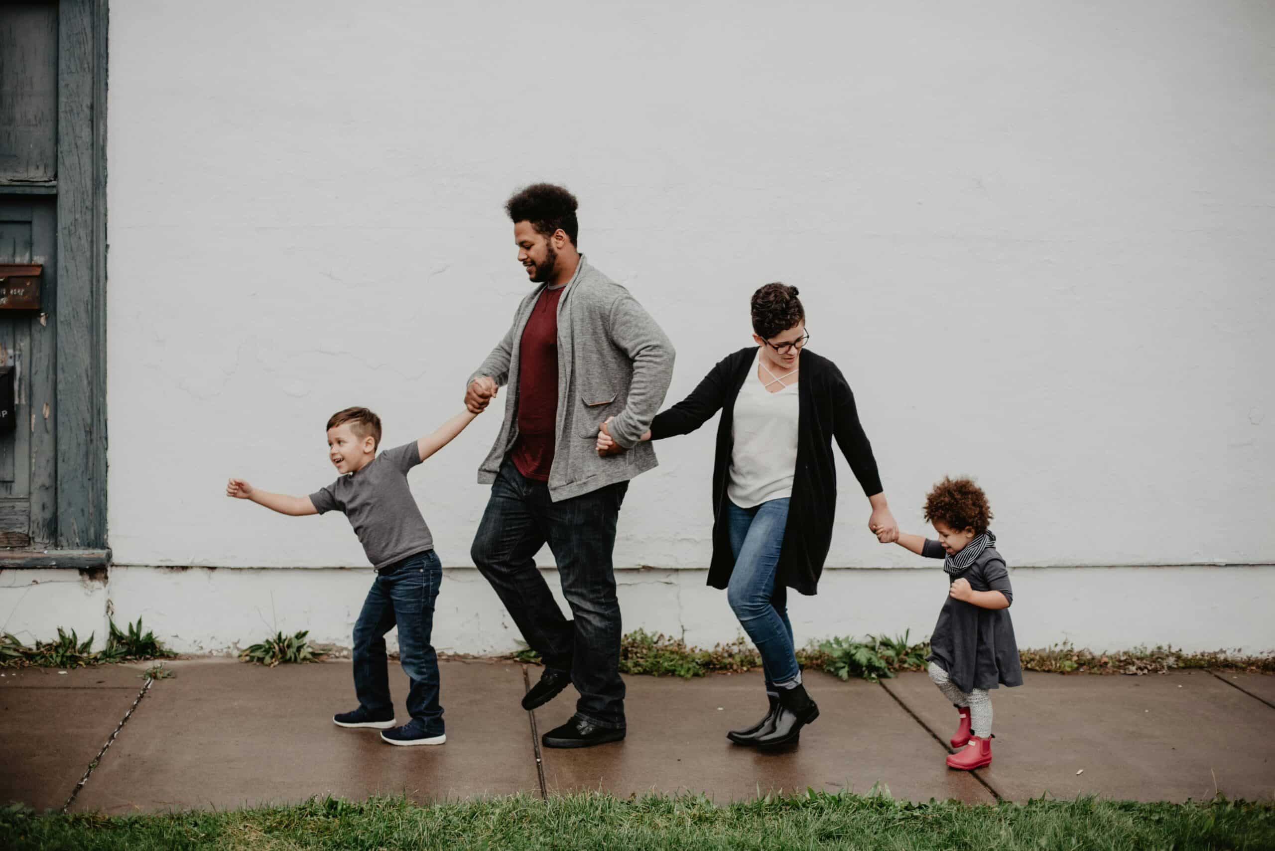 family with autistic kids skipping