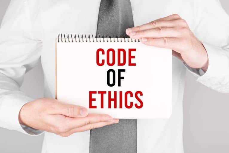 ABA Ethics Code written on a paper held by a guy in a white polo shirt