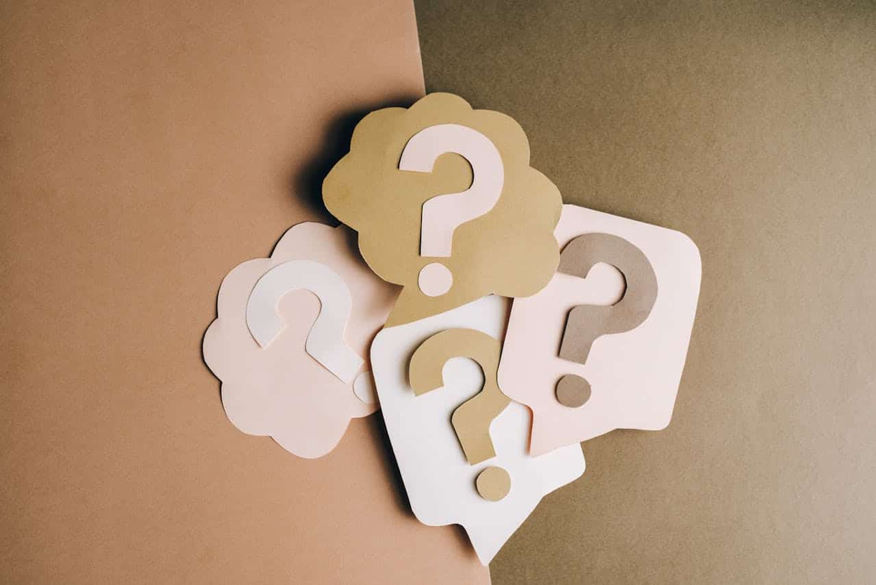 ABA therapy FAQs represented by brown and pink question marks