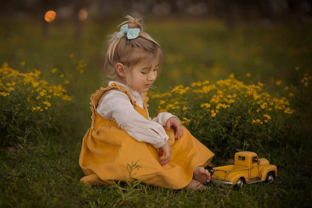 A child with autism wearing oversized eyewear, looking thoughtful