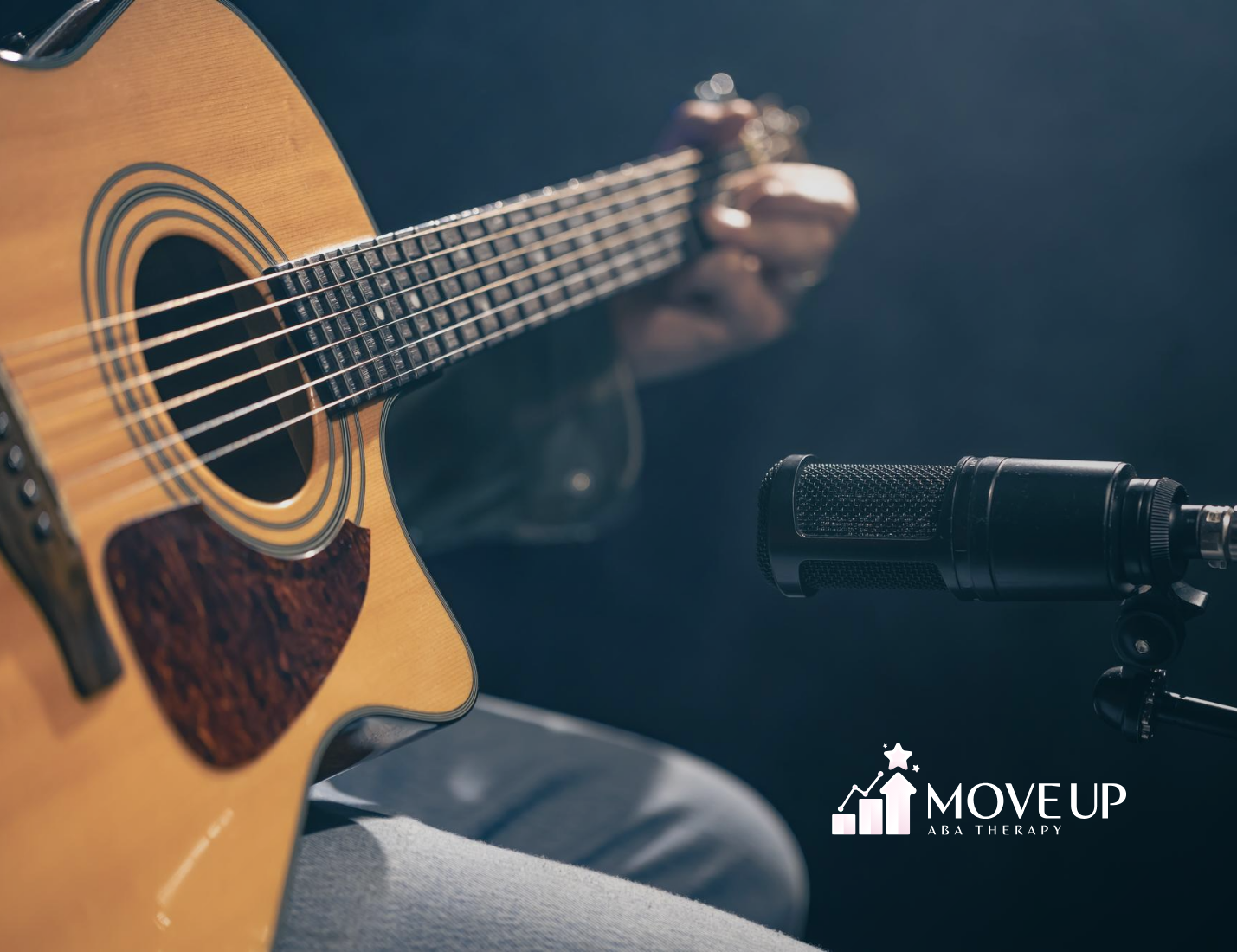 A musician playing a guitar in front of a microphone, representing Ed Sheeran