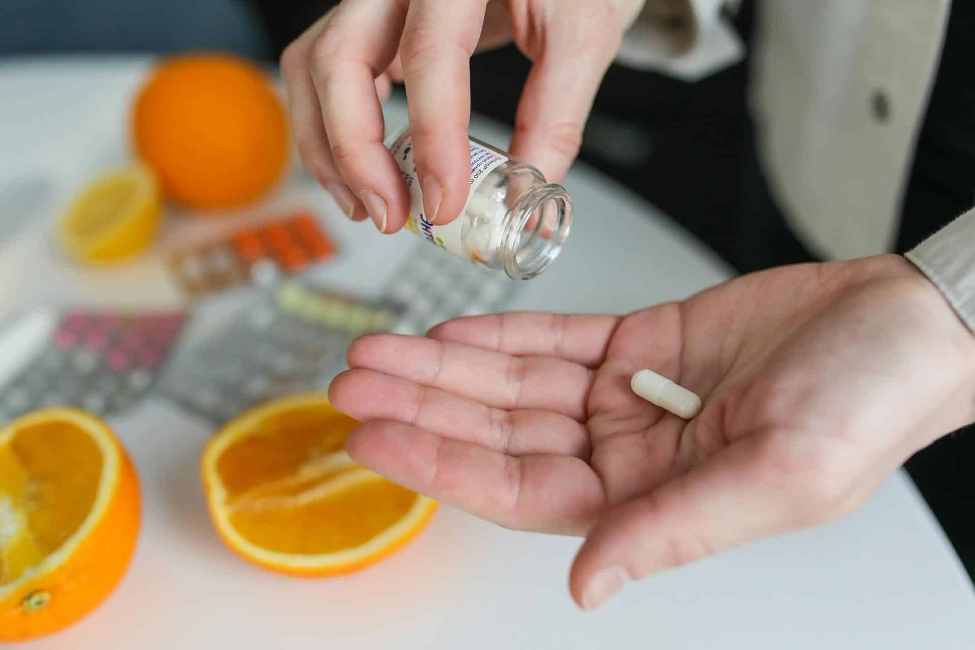 Vitamin C pill in palm