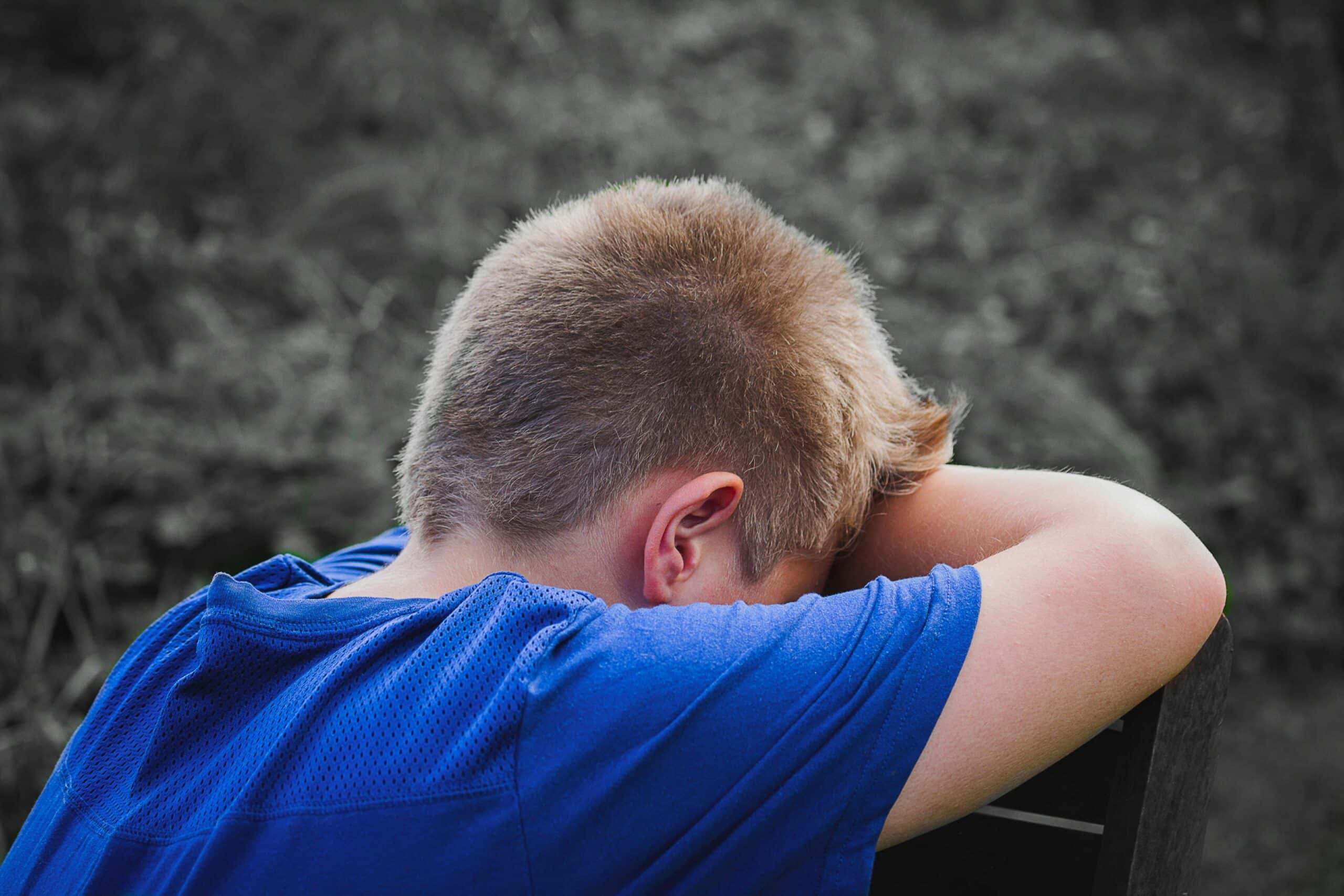 crying kid in a blue shirt