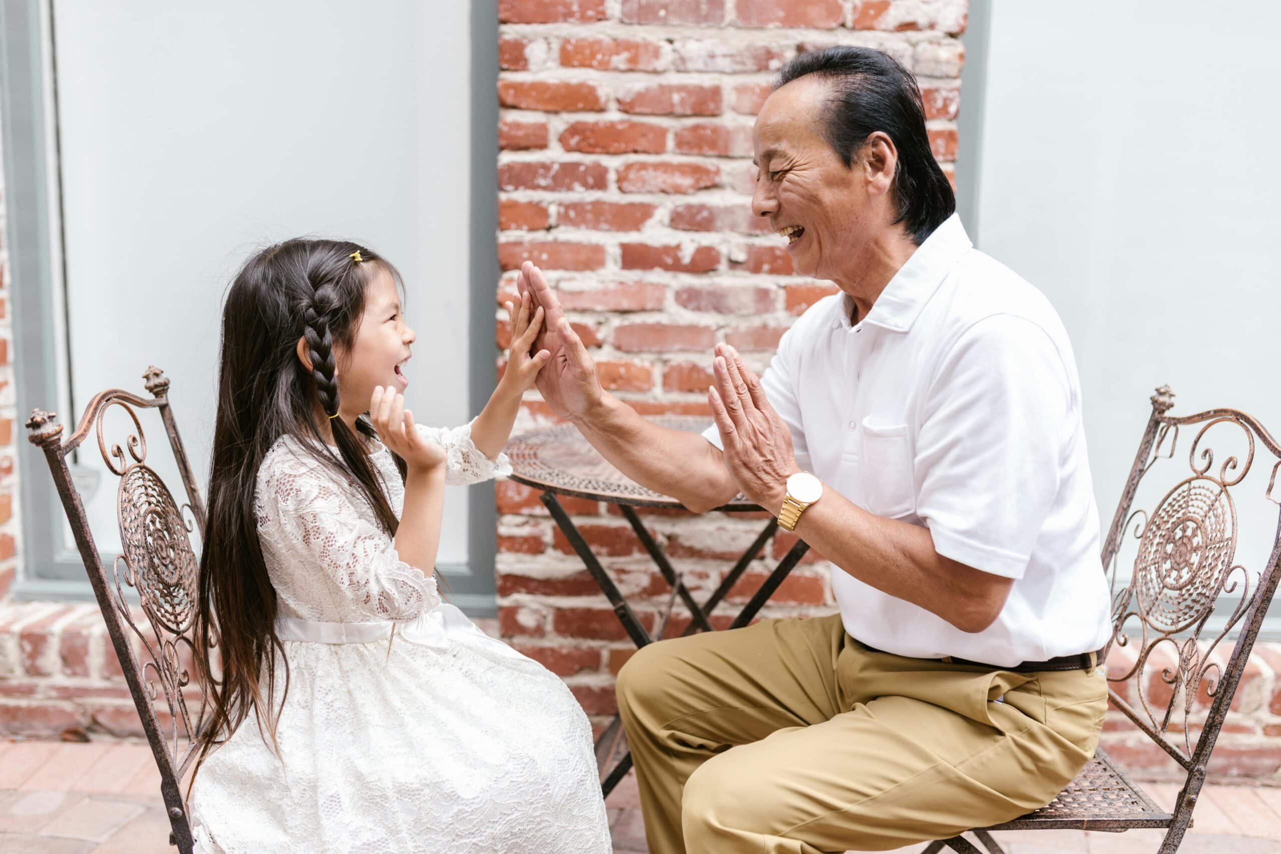 dad with autistic daughter playing while sitting