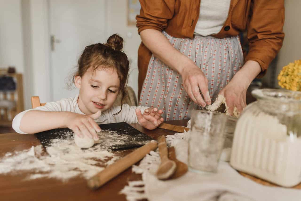 positive reinforcement for autistic girl helping out with kneading the flour