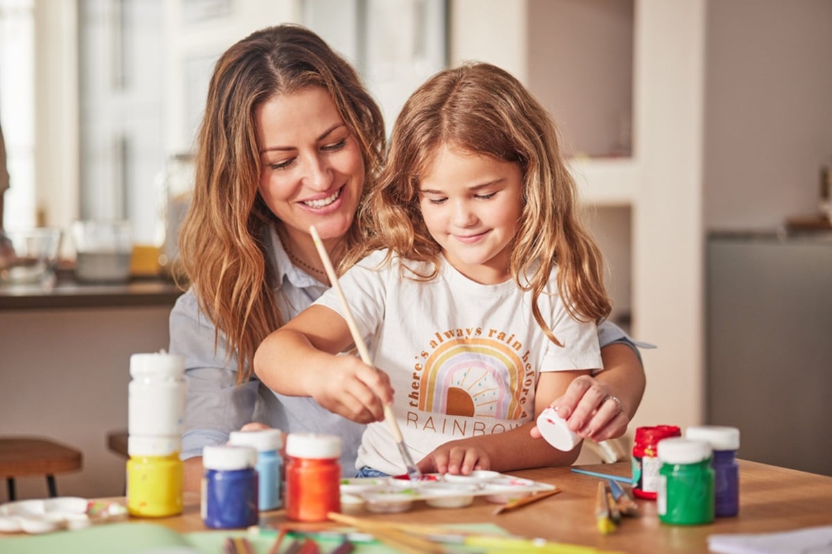 An ABA therapist engaging with a young girl in a center-based therapy session