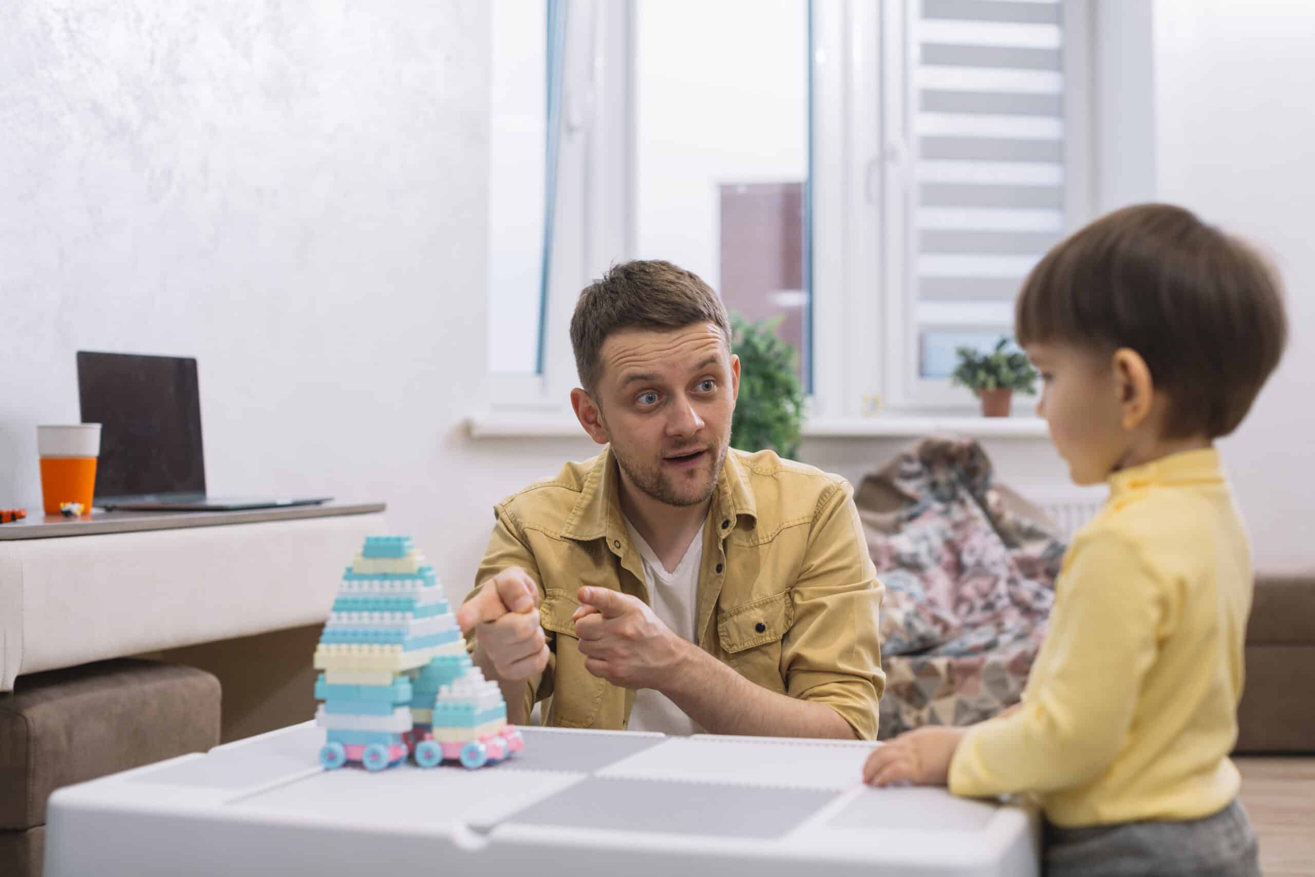 Child with Autisms father teaching son