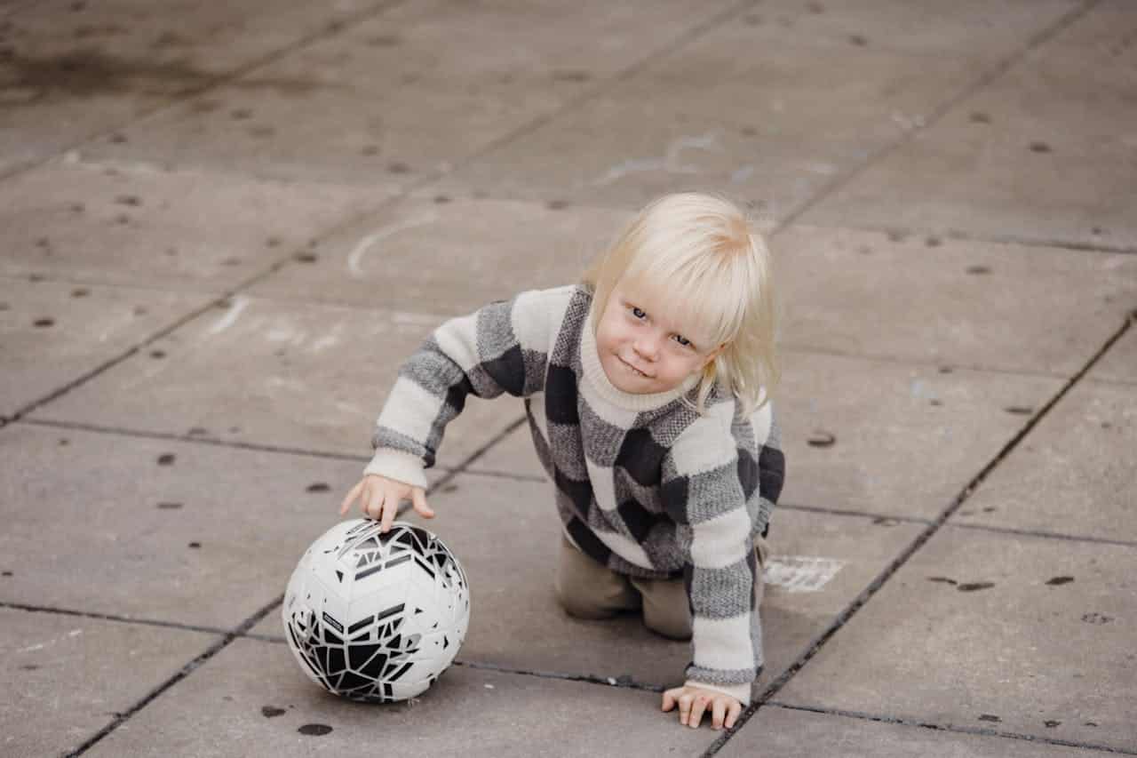 Early Intervention for Autism wtih a kid playing with a ball