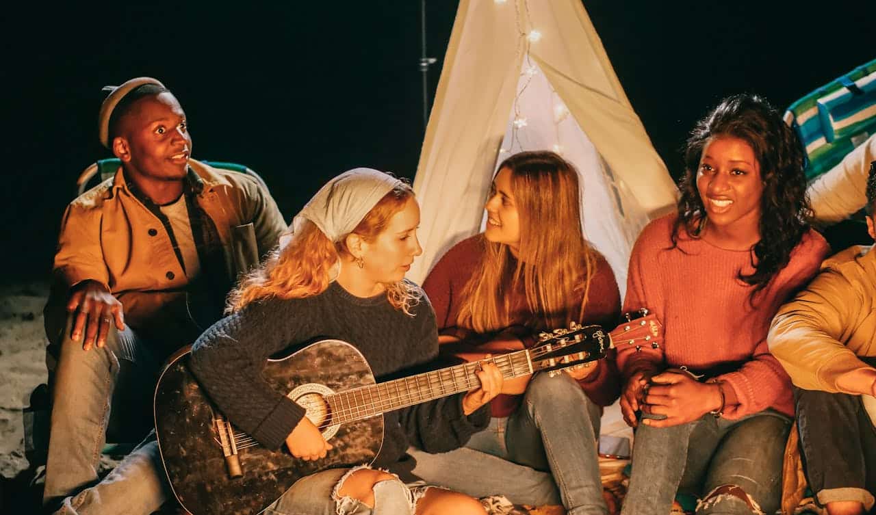 Happy people around a campfire