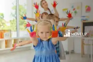 a group of toddlers with paint on their hands