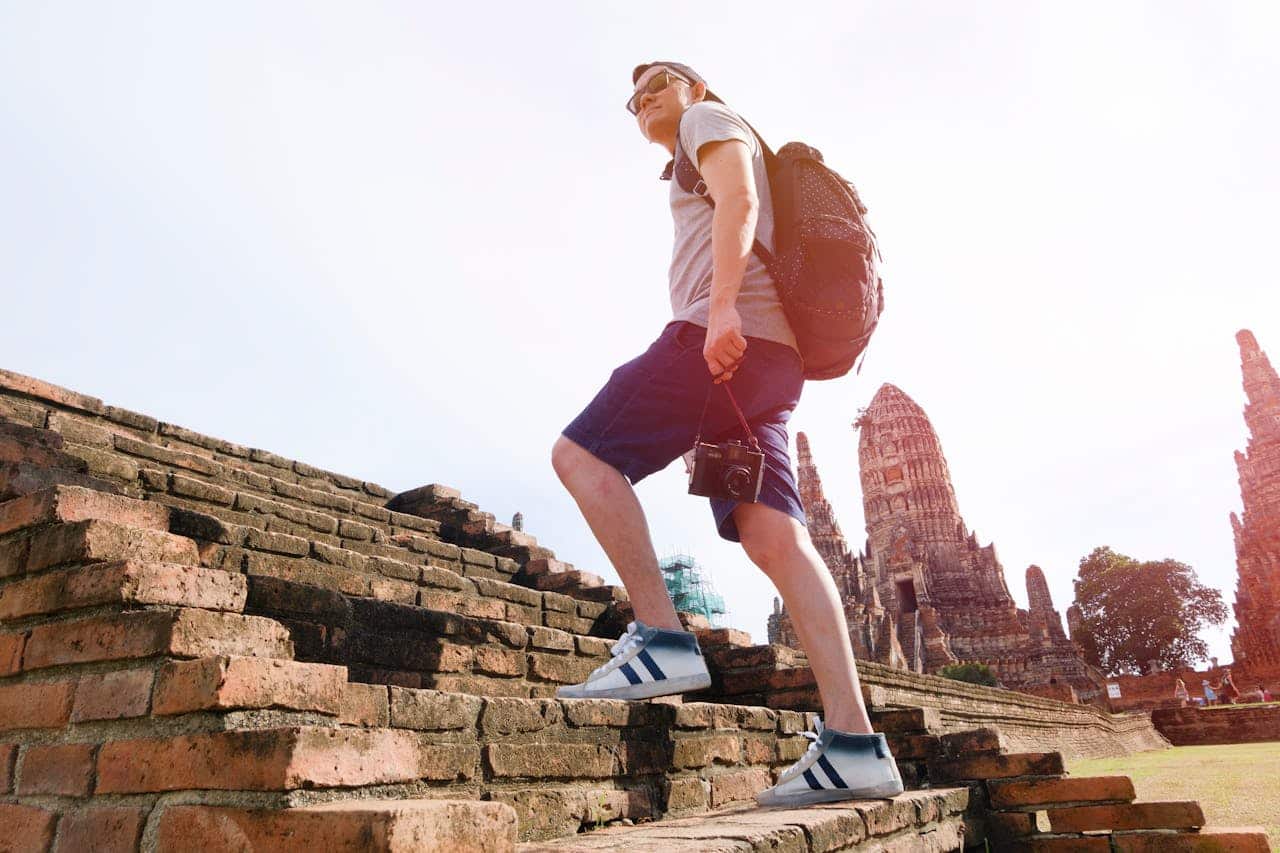 guy climbing the stairs of a temple