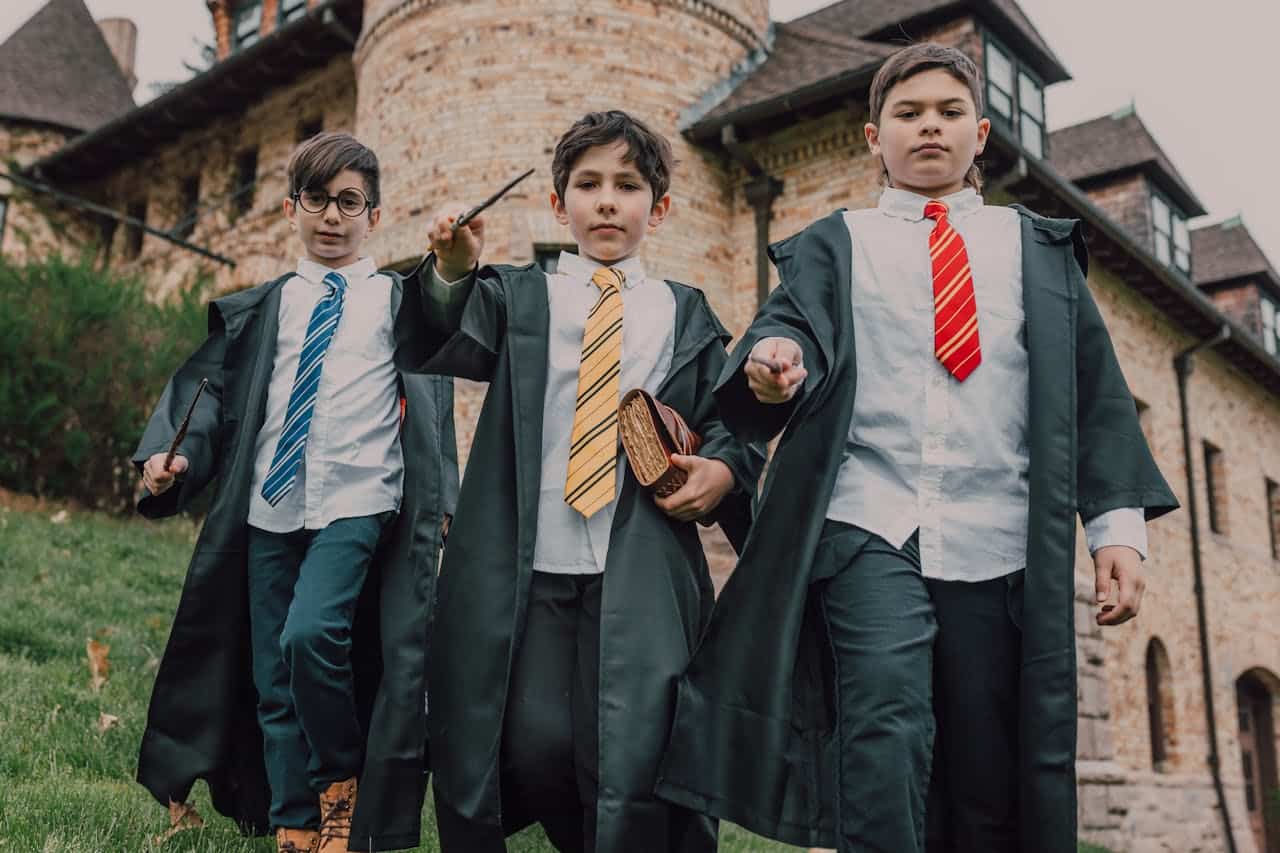 kids in harry potter uniforms weilding their wands