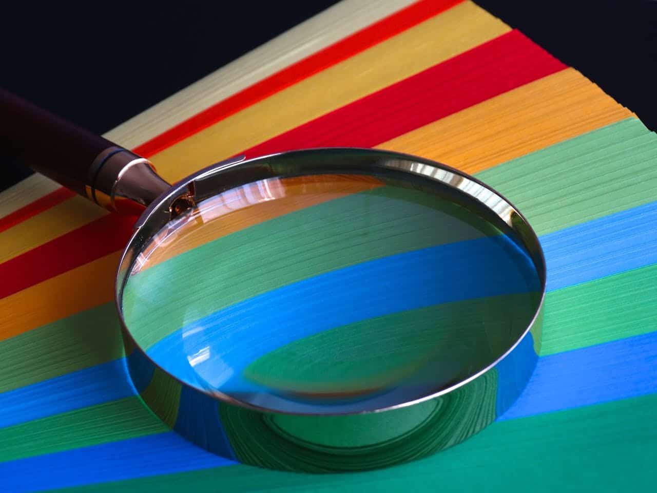 magnifying glass atop colored paper for ABA therapy goals