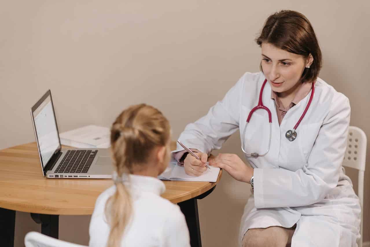 pediatrician checking up on an autistic child