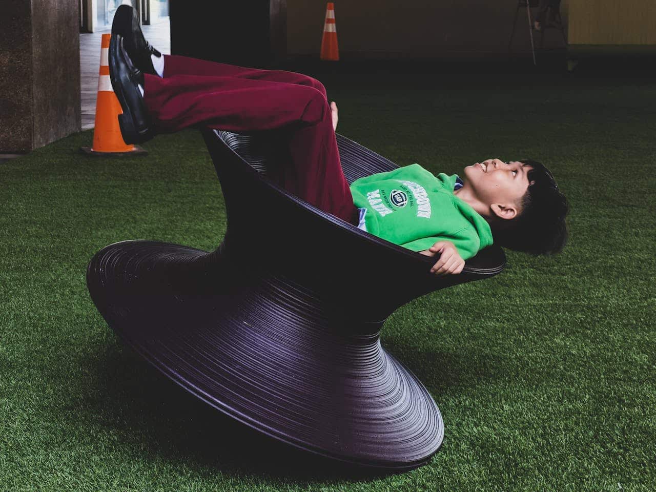 teenager rocking in a chair looking up for ABA therapy