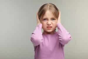 A little girl with spd irritated by the noise