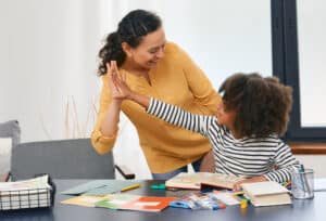 ABA Therapy session kid high fiving caretaker