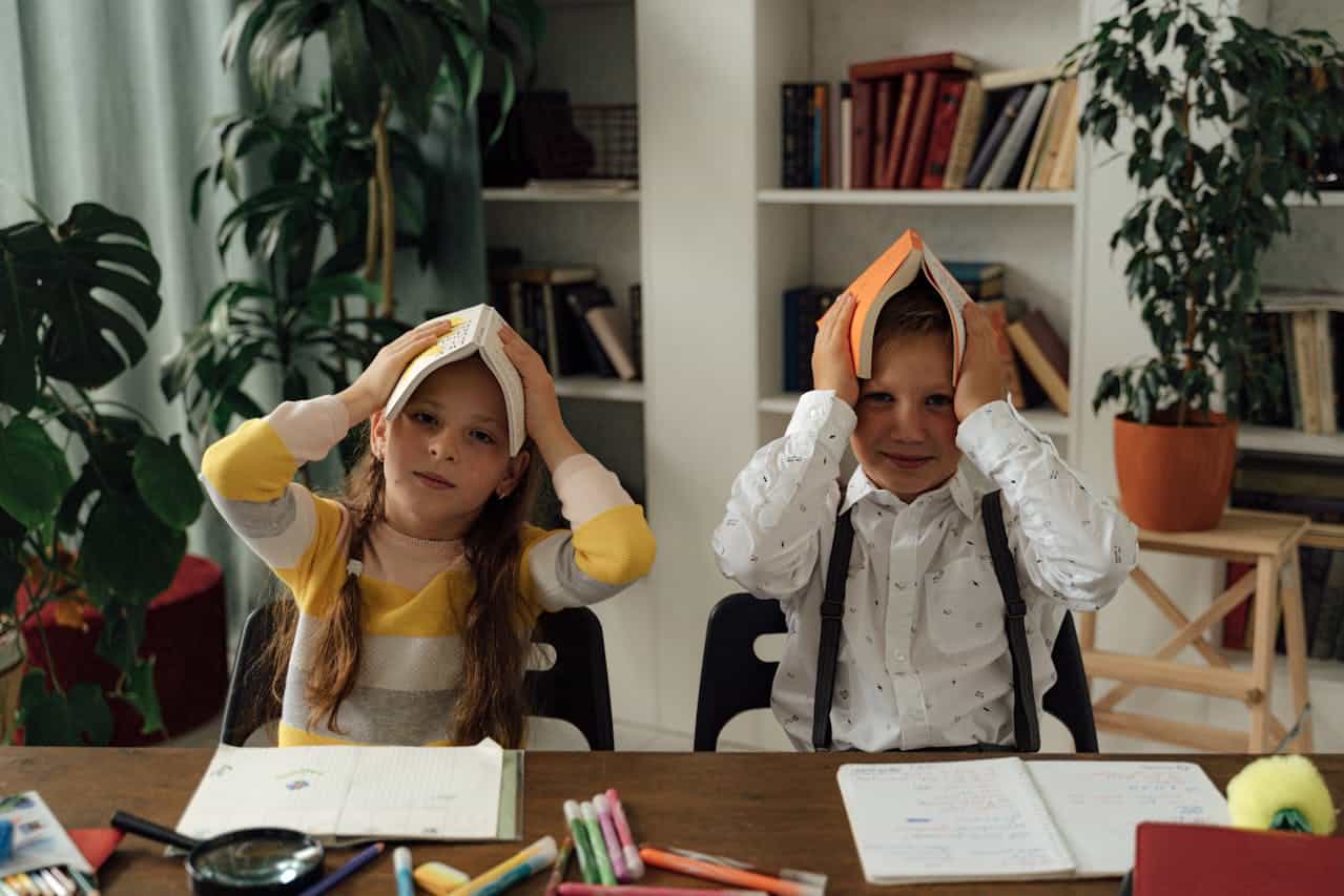 ABA therapy children at school their books atop their heads for an exercise