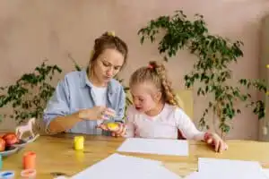 An aba therapist teaching the girl to paint