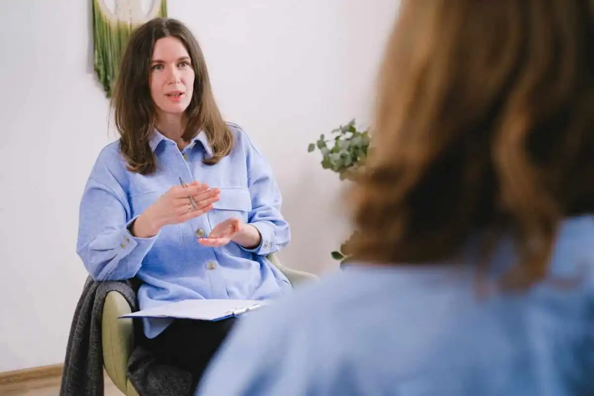 An applied behavior analyst therapist talking to her client