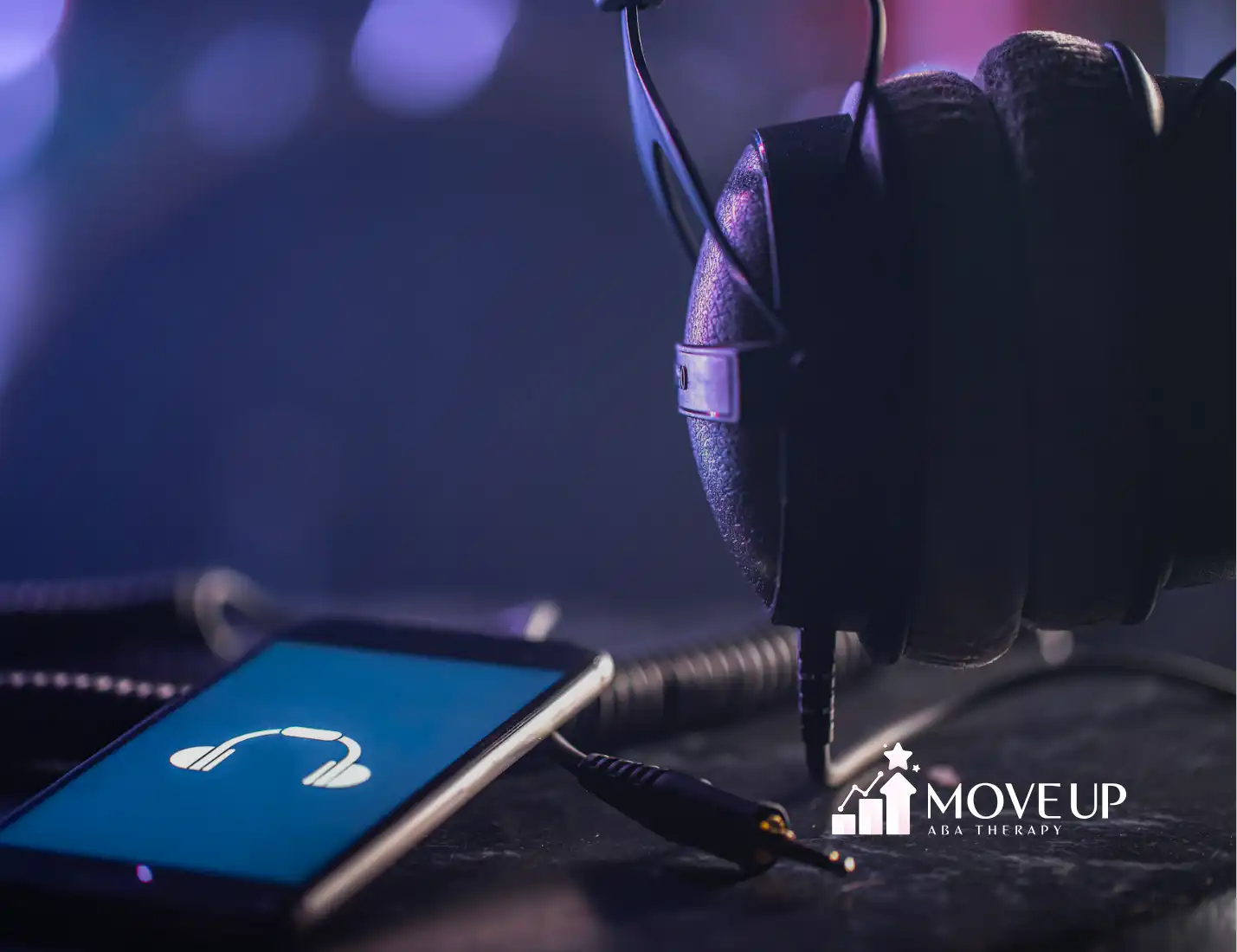 A pair of headphones and a mobile phone