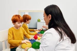 Mother uisng sensory ball at home for ABA Therapy