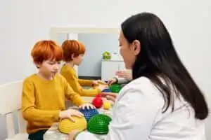 Mother uisng sensory ball at home for ABA Therapy