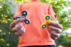 a boy playing fidget spinner