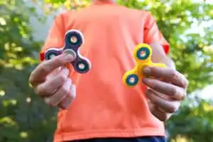 a boy playing fidget spinner