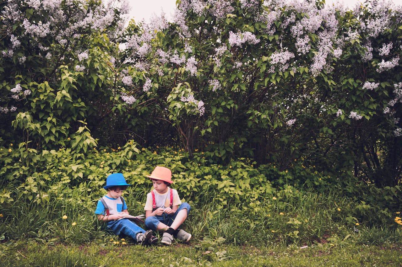 brothers outside sitting on grass for aba therapy