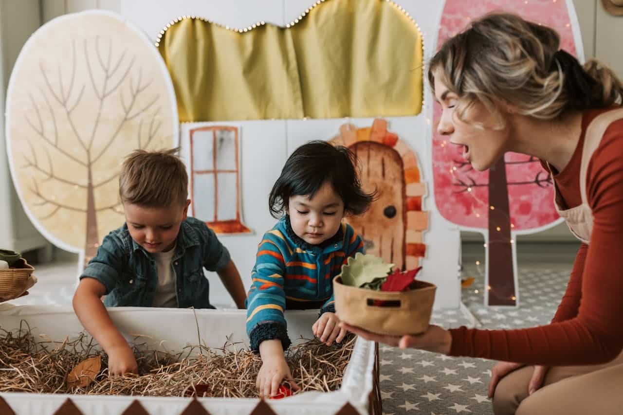 caretaker teaching kids about leaves