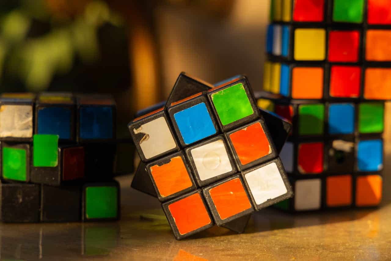 disarranged rubix cubes on a table