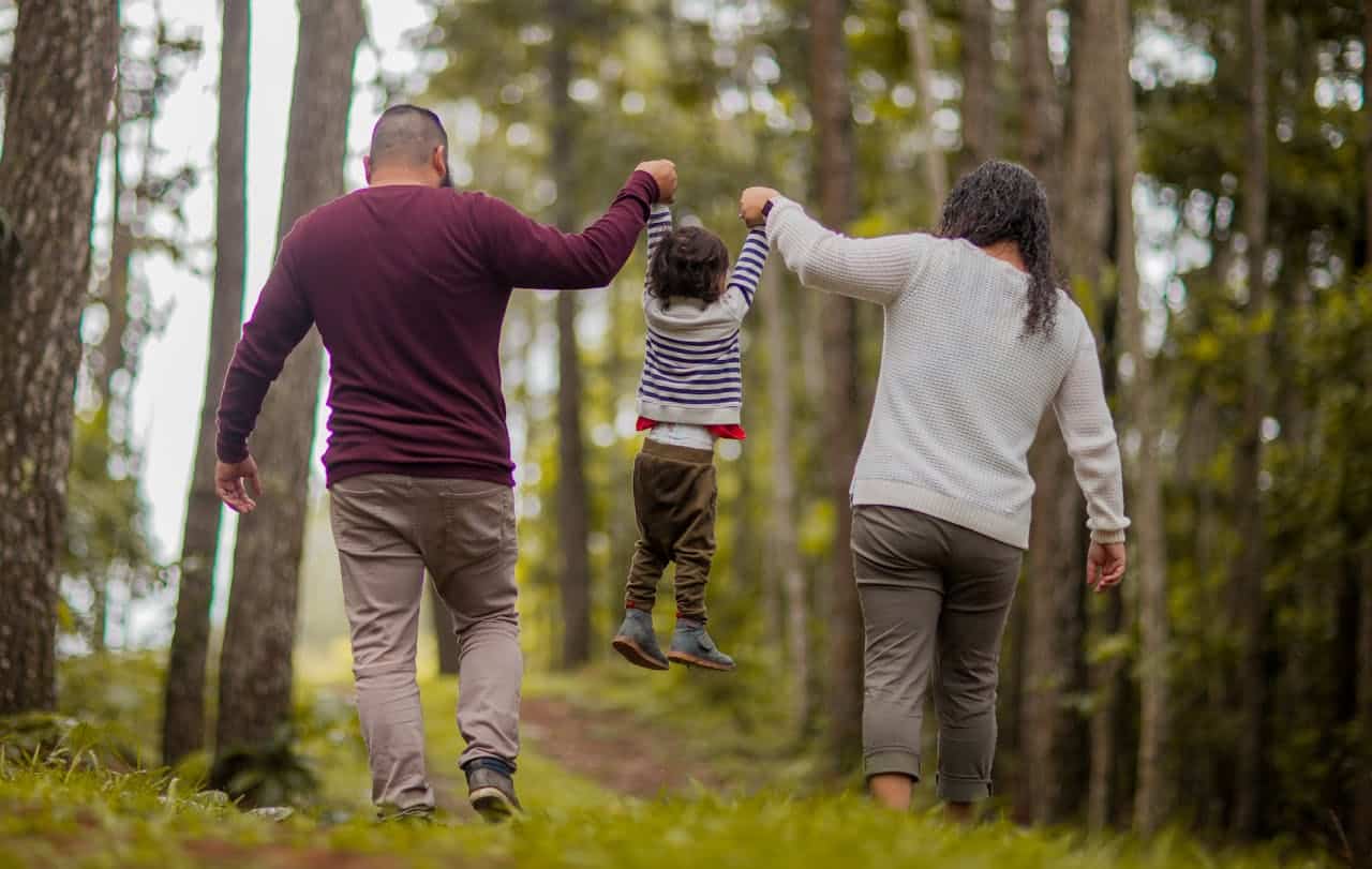 family trekking in the woods after ABA therapy