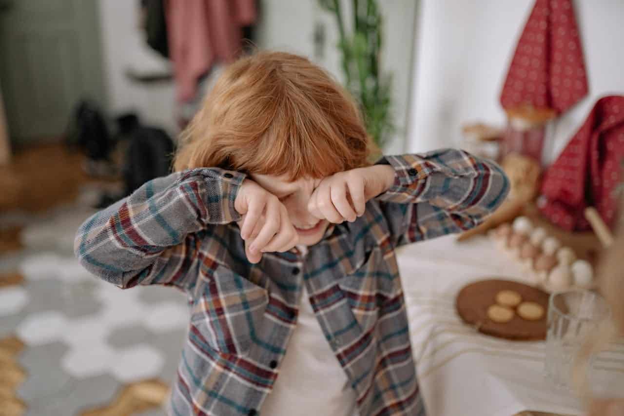 ginger child with autism throwing a tantrums