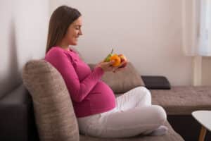 healthy pregnant woman sitting on the couch