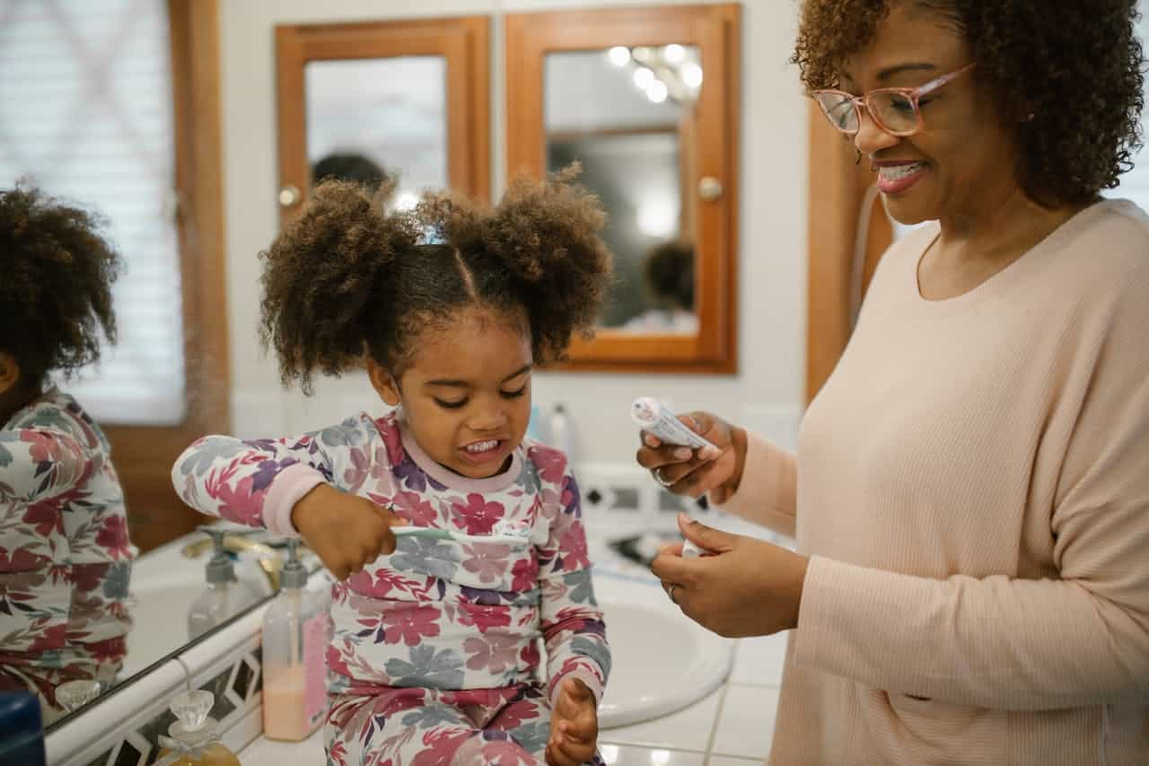 kid brushing her teeth for importance of routin in autism