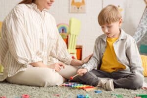 little boy playing autism toys ,a xylophone