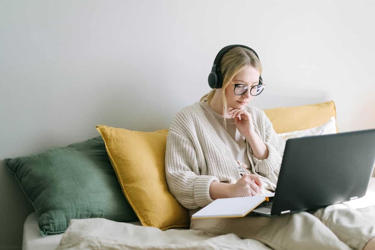 mom typing on her laptop while on the couch