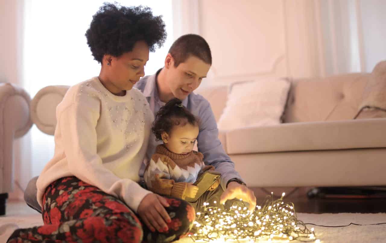 parents teaching girl about fairy lights