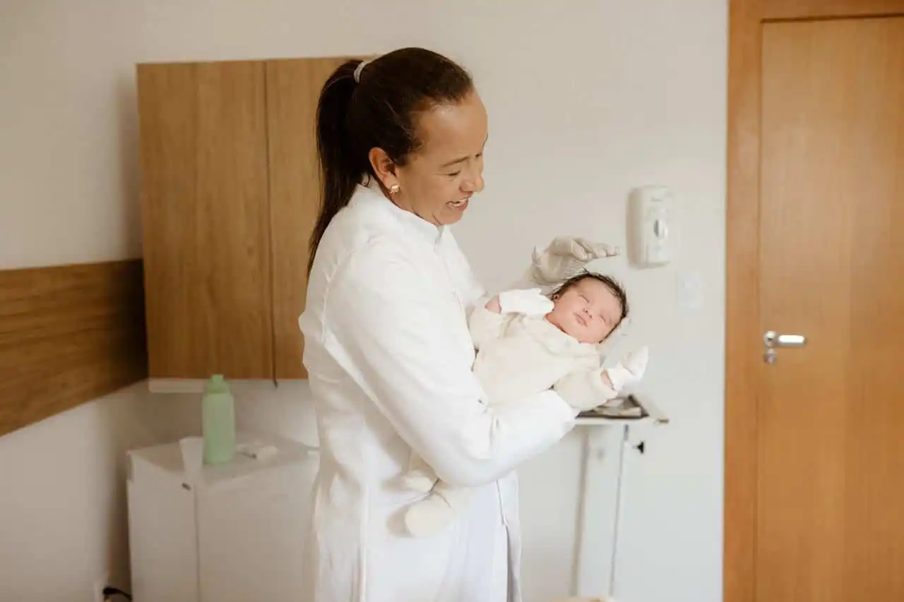 pediatrician holding baby while answering what is autism