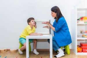 therapist working with little boy for a therapy